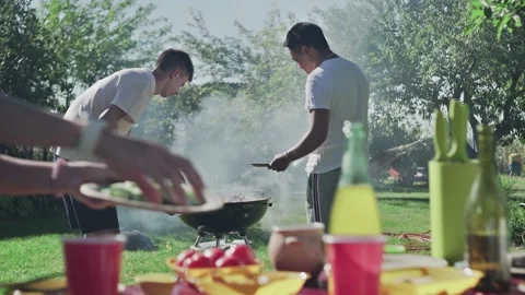 Young friends are preparing bbq party outdoors Video stock 143471361