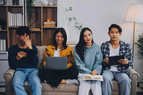 Young friends doing school assignment together at home Stock Photos