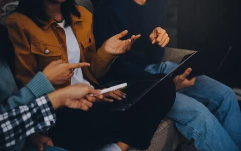 Young friends doing school assignment together at home Stock Photos