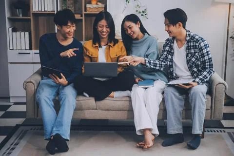 Young friends doing school assignment together at home Stock Photos