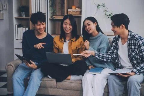 Young friends doing school assignment together at home Stock Photos