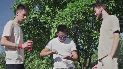 Young friends grilling bacon on grid. Friends are camping in weekend. Stock Footage 143468973