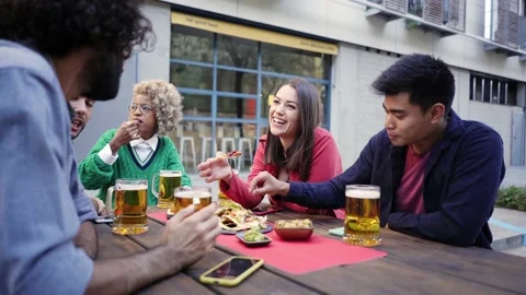 Young friends having fun outdoors. Happy group people enjoying together at Bar Stock Footage 205048904