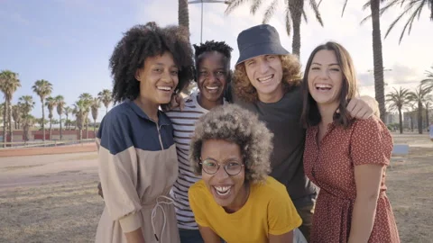 Young friends looking at smiling camera. Group of people having fun outdoors Stock Footage 161361075