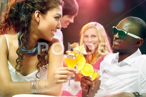Young friends meeting and drinking at club Stock Photos