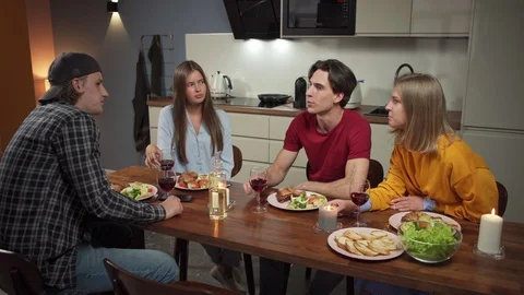 Young friends talking at dinner Stock Footage 114808505
