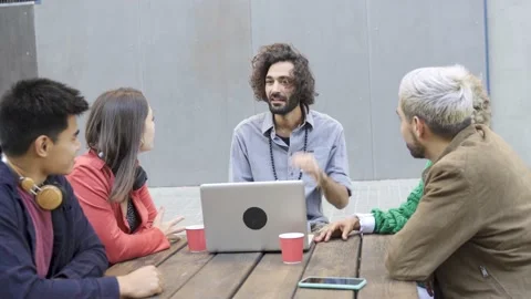 Young friends using computer laptop during meeting outdoor in the city Stock Footage 168251441