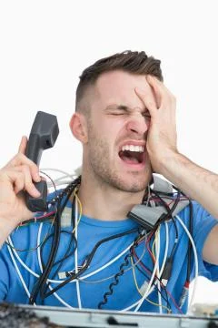 Young frustrated computer engineer on call Stock Photos