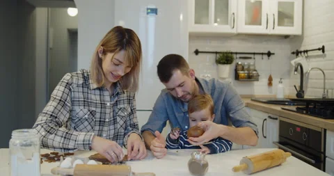 Young full family having fun baking cookies in the kitchen together Stock Footage 146114875