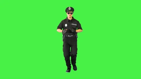 Young fully equipped policeman runs on a Green Screen, Chroma Key. Stock-Footage 156904989
