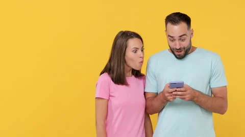 Young fun couple friends bearded man woman 20s posing isolated on yellow Stock Footage 148323341