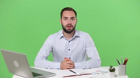 Young fun employee man sit work desk pc laptop computer pointing showing hands Stock Footage 136284548