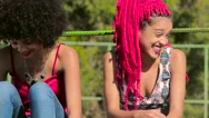 Young Funky Friends Sitting Near A Fence And Chatting Stock Footage