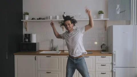 Young funky guy funny dancing in kitchen. H Stock Footage 158157524