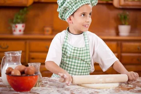 Young funny boy playing with flour  in the kitchen Foto stock