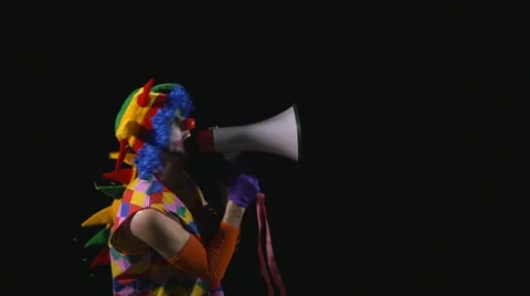 Young funny clown using a megaphone and shouting Stock Footage 60427474