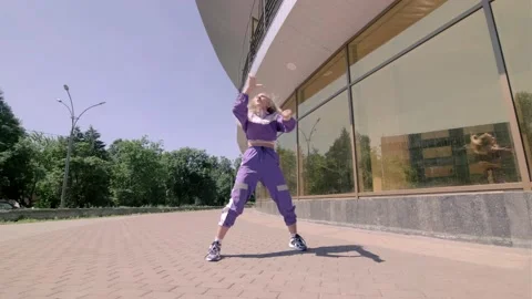 Young funny girl dancing modern dance, hip hop in the open air. Gimbal shot Stock Footage 133607034