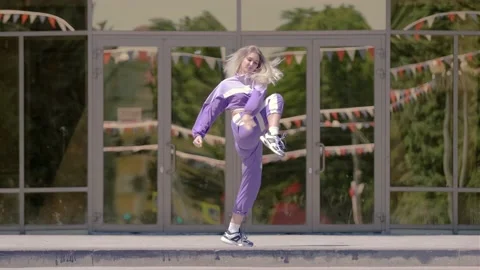 Young funny girl dancing modern dance, hip hop in the open air. Youth subculture Stock Footage 133607040