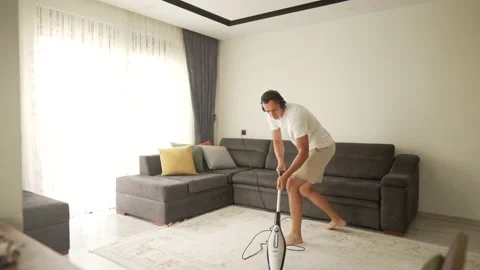 Young Funny Man Dancing With Vacuum Cleaner Playing Guitar. Vídeo Stock 195785752