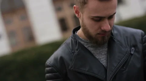 Young funny man with grey eyes talking on his phone in the street Stock Footage 63468902