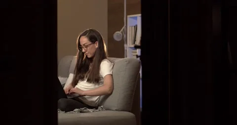Young game blogger writes an article on a laptop at home Video stock 132445169