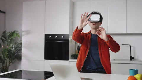 Young game designer testing VR application in headset at home, freelance work Stock Footage 337907141