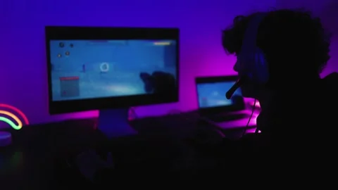 Young gamer having fun playing online video games with computer at home Video stock 225056025