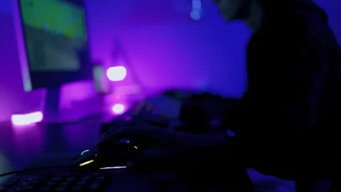Young gamer having fun playing online video games with computer at home. Gaming  Stockbeeldmateriaal 323555025