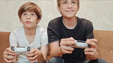Young Gamer: Teen Boys Immersed in Stock Video Pond5