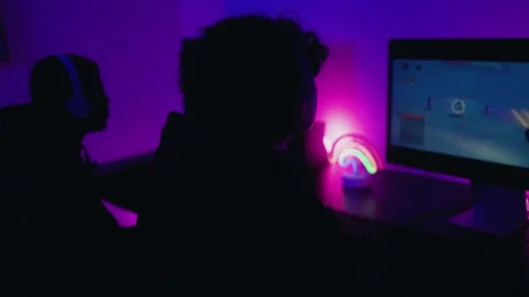 Young gamers having fun playing online video games with computer at home Video stock 225055970