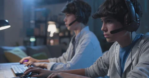 Young gamers playing video games together Stock Footage 168240933