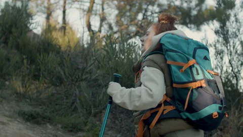 Young ginger-haired lady trekking in natural park Stock Footage 172522678