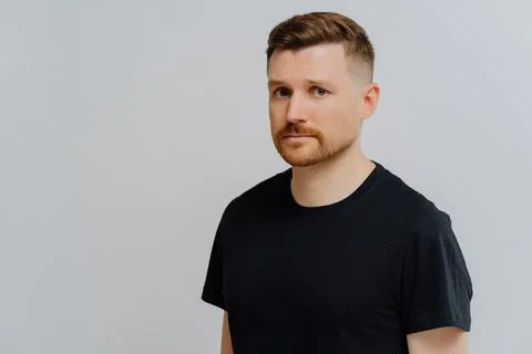 Young ginger man feeling sad and disappointed, looking at camera with frustrated Stock Photos