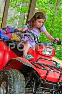 Young girl on a 4-wheeler atv Stock Photos