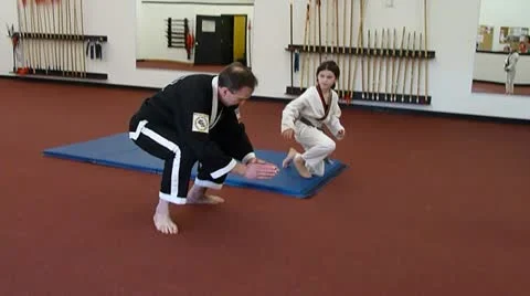 Young Girl and Instructor Practice Martial Arts Stock Footage 10849536