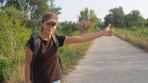 A young girl with a backpack is hiking. Stock Footage