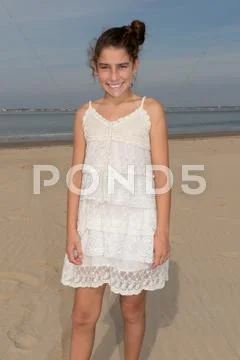 Young girl at beach with white dress Stock Photos
