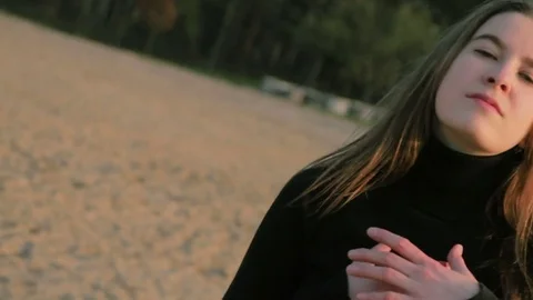 Young girl in black clothes dancing, at riverside Stock Footage