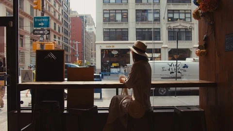 Young girl in a cafe by the window Stock Footage 119443244