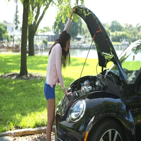 A young girl calls for help when her car breaks down (slow motion) Stock Footage