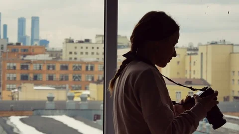 Young girl with a camera in hand. Close-up. Stock Footage 103947341
