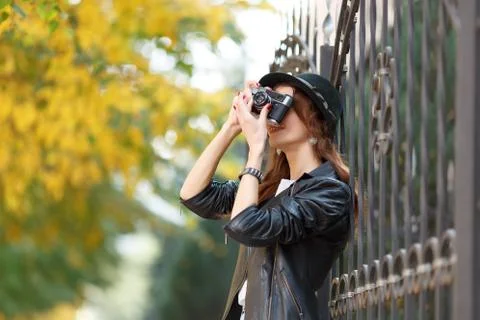Young girl with camera outdoors Stock Photos
