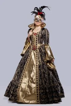 Young girl in carnival costume with mask Stock Photos