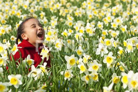 Young girl child playing spring time field Stock Photos