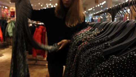 Young girl is choosing clothes at the store Video stock 123722038