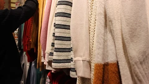 Young girl is choosing clothes at the store Stock Footage 123722110