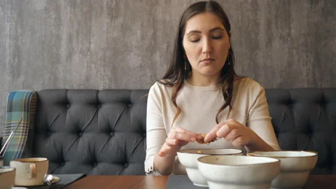 Young girl cleans and eats shrimp in a restaurant Stock Footage 103450068