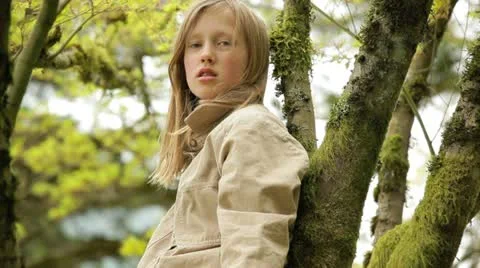 Young girl climbing a tree Stock Footage 10921159