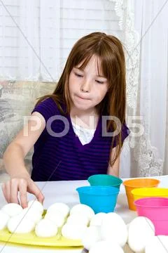 Young Girl Coloring Easter Eggs