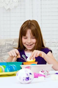 Young girl coloring Easter Eggs Stock Photos
